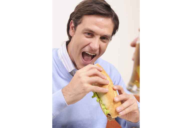 a man about to take a bite on the sandwich