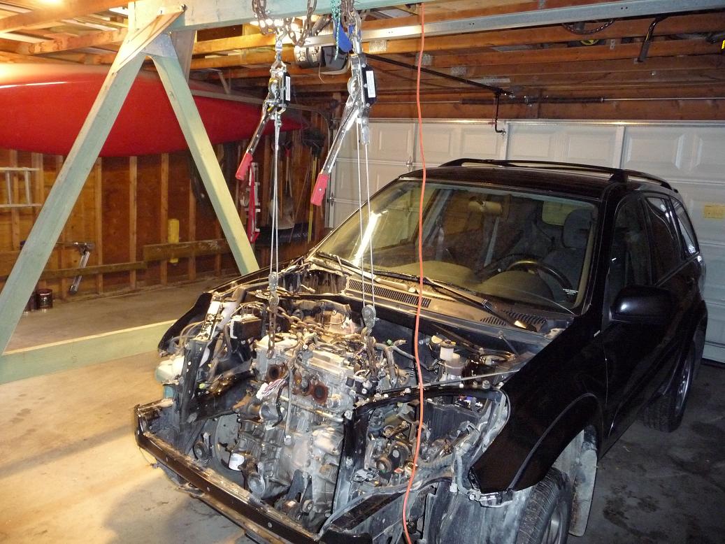 car engines about to be removed from the car using a swingset